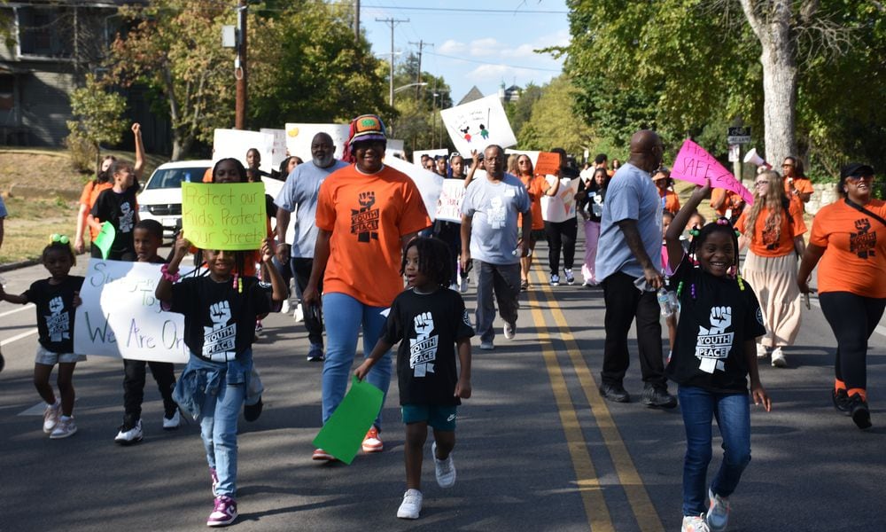 Kids, teens and adults marched down Broadway Street in northwest Dayton on Thursday as part of a peace march and rally in response to an increase in gun violence in the community. CORNELIUS FROLIK / STAFF