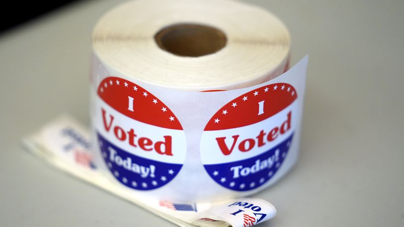 FILE - A spool of stickers rests on a table at a polling station during Massachusetts state primary voting, Sept. 3, 2024, in Newton, Mass. (AP Photo/Steven Senne, File)