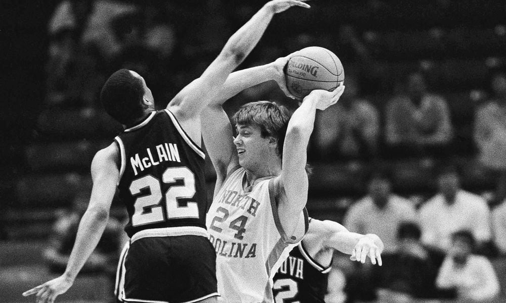 North Carolina's Joe Wolf (24) is stopped by Villanova players Gary McLain (22) and Harold Jensen (32) during early action at NCAA Southeast Regional finals at Birmingham, Ala., March 24, 1985. (AP Photo/File)