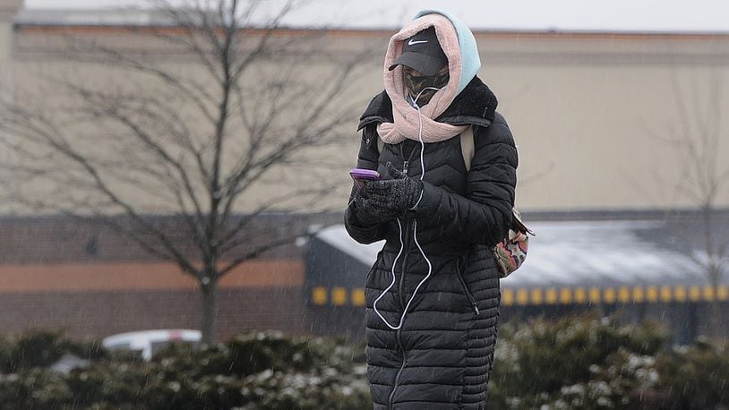 FILE A woman bundles up against the cold as she walks along Old Troy Pike in Huber Heights, Monday, Jan. 25, 2021. MARSHALL GORBY\STAFF