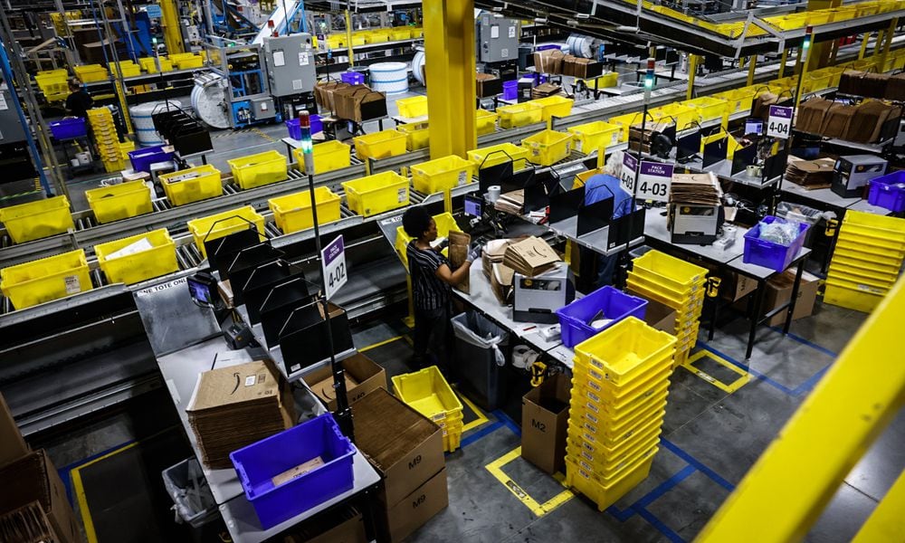 Workers at the Amazon Union Fulfillment Center work with packages during an open house Thursday August 21, 2024. JIM NOELKER/STAFF