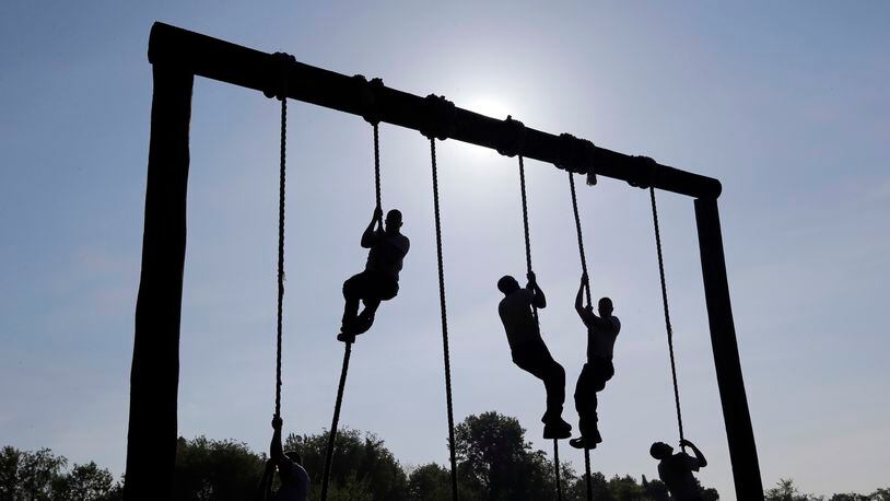 FILE - Freshman midshipmen, known as plebes, climb ropes on an obstacle course during Sea Trials, a day of physical and mental challenges that caps off the freshman year at the U.S. Naval Academy in Annapolis, Md., May 13, 2014. (AP Photo/Patrick Semansky, File)