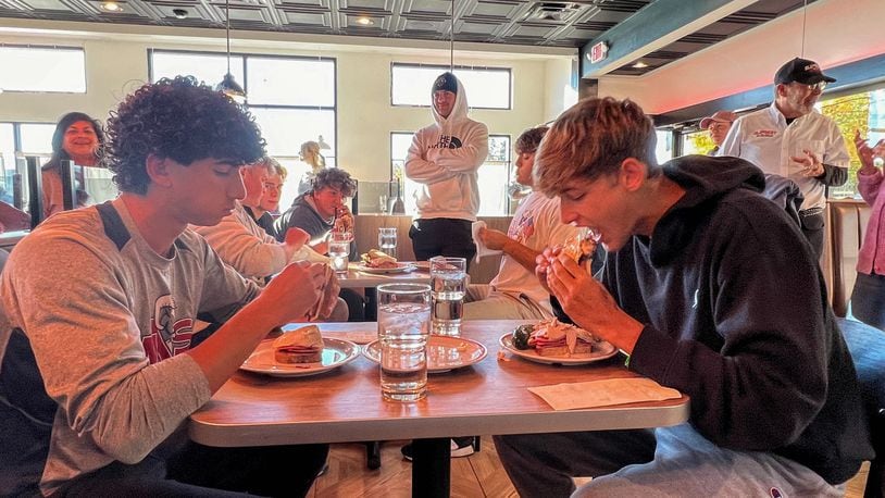 Student athletes from Centerville High School and The Miami Valley School battled head-to-head on Oct. 22 to see who could eat All The Best Delicatessen’s secret menu item, “The Stupid-Big Sandwich,” in the fastest time. CONTRIBUTED PHOTO