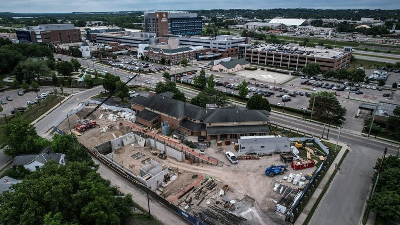 In the foreground, the Ronald McDonald House expansion on Valley Street across from Dayton Children's Hospital continues to progress. This photo was taken in June. The $29 million lodging facility for families of hospitalized children will triple its original size. JIM NOELKER/STAFF