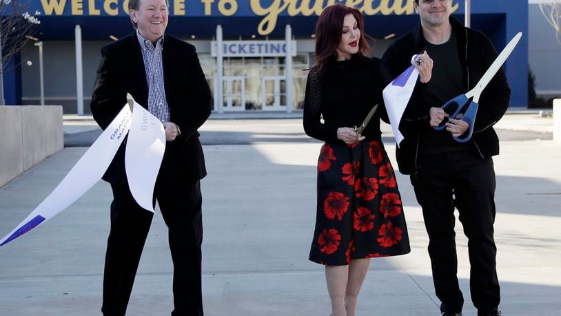 FILE - Priscilla Presley, center, cuts the ribbon with Jack Soden, left, Elvis Presley Enterprises president, and Joel Weinshanker, Graceland Holdings managing partner, during the grand opening of the "Elvis Presley's Memphis" complex, March 2, 2017, in Memphis, Tenn. The Memphis Music Hall of Fame inducted its inaugural class of 25 luminaries at a rousing ceremony 12 years ago, honoring legends spanning generations and genres, from Elvis Presley to ZZ Top to Three 6 Mafia. (AP Photo/Mark Humphrey, File)