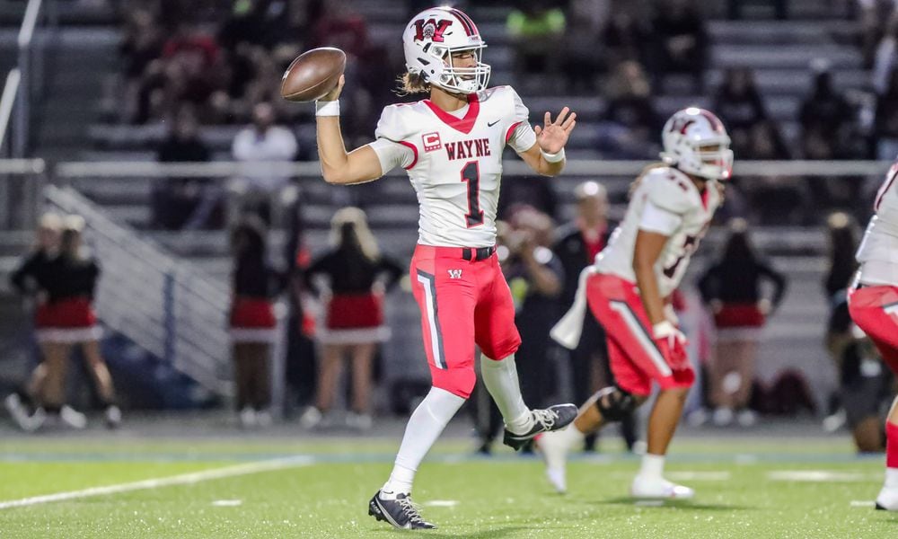 Wayne High School senior quarterback Tyrell Lewis prepares to throw a pass during their game against Springfield on Friday night in Springfield. The Warriors won 36-6. CONTRIBUTED PHOTO BY MICHAEL COOPER