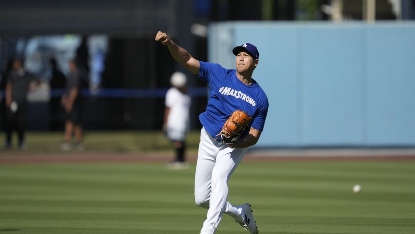 Los Angeles Dodgers designated hitter Shohei Ohtani works out before a baseball game against the Tampa Bay Rays in Los Angeles, Saturday, Aug. 24, 2024. (AP Photo/Ashley Landis)