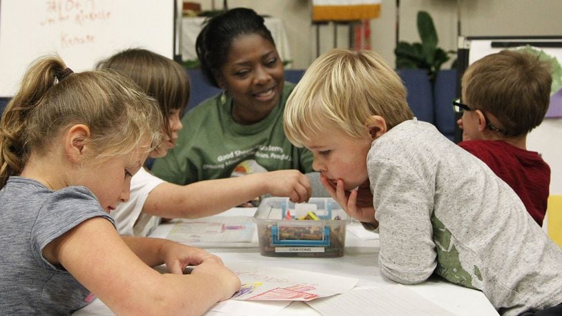 Good Shepherd Academy center manager Eartha DeWalt works with students in a classroom within the Jubilee Community Church in Springboro. TY GREENLEES / STAFF