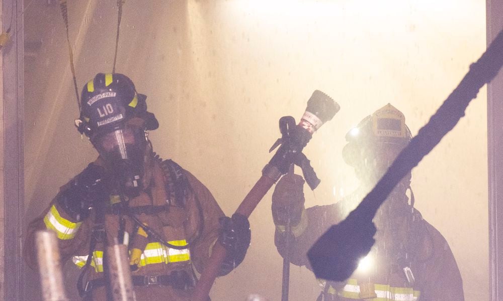 Firefighters with the 788th Civil Engineer Squadron Fire Department, work in the smoke, steam and water of a room on fire July 18 in building 18, on Area B, Wright-Patterson Air Force Base. Fifteen firefighters from the Wright-Patt Fire Department and 4 firefighters from the City of Riverside Fire Department responded to the alert. (Air Force photo by R.J. Oriez)