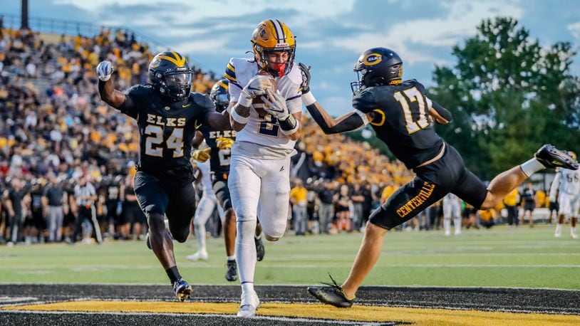 Cutline: Springfield High School senior Bop Wafer catches a touchdown pass between Centerville two defenders during their game on Friday night at Centerville Stadium. The Wildcats won 17-3. Michael Cooper/CONTRIBUTED