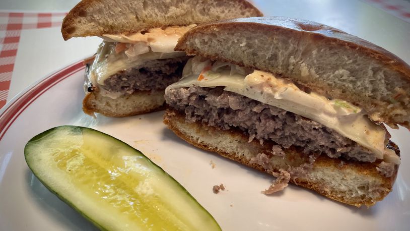 All The Best Delicatessen is now offering the Bestie Burger, a 6 oz. all beef burger topped with Swiss cheese, coleslaw and Russian dressing on a grilled challah knot. NATALIE JONES/STAFF