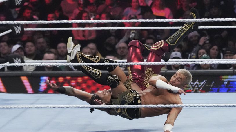 FILE - Wrestler Carmelo Hayes, top, tangles with Akira Tozawa during the WWE Monday Night RAW event, March 6, 2023, in Boston. This year's WrestleMania may be just days away, but the marketing run up to WWE's biggest premium live event went into overdrive months ago. (AP Photo/Charles Krupa, File)