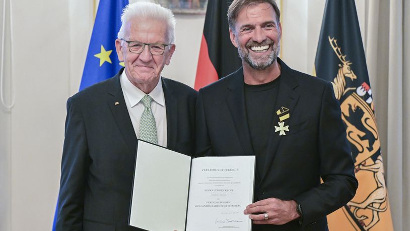 Soccer coach Juergen Klopp, right, receives the Order of Merit of the German State of Baden-Wuerttemberg in Stuttgart, Germany, Tuesday, Oct. 8, 2024, from Governor Winfried Kretschmann, left, for his wide-ranging social commitment outside of sport. (Bernd Weissbrod/dpa via AP)