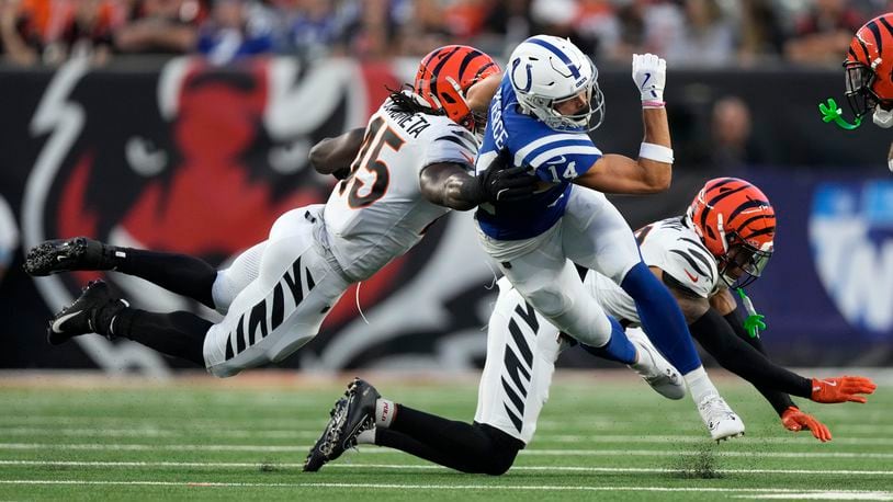 Indianapolis Colts wide receiver Alec Pierce (14) is tackled by Cincinnati Bengals linebacker Maema Njongmeta (45) during the first half of a preseason NFL football game, Thursday, Aug. 22, 2024, in Cincinnati. (AP Photo/Carolyn Kaster)