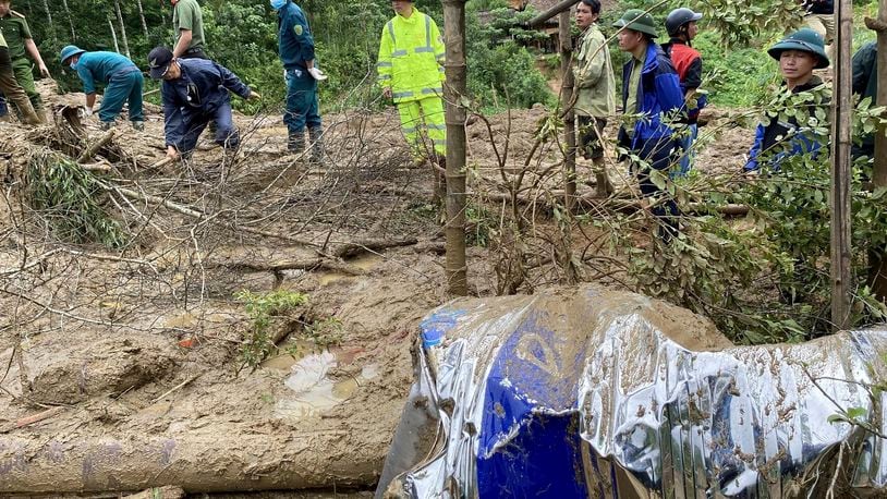 Rescue workers clear mud and debris brough down by a flood in Lang Nu hamlet in Lao Cai province, Vietnam Tuesday, Sep. 10, 2024. (Pham Hong Ninh/VNA via AP)