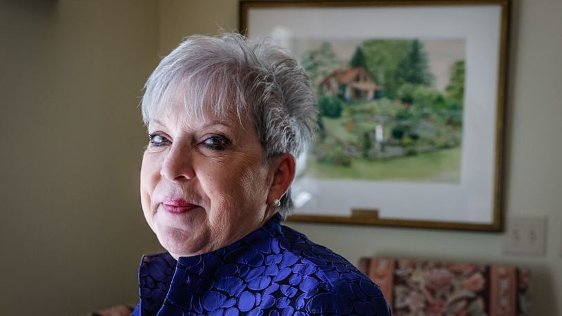 Carol Collins is the Director of Leisure Service and Horticulture for the City of Oakwood. The painting behind Collins is Smith Gardens. JIM NOELKER/STAFF