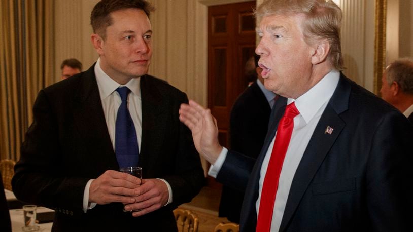 FILE - President Donald Trump, right, talks with Tesla and SpaceX CEO Elon Musk at the White House in Washington, Feb. 3, 2017. (AP Photo/Evan Vucci, File)