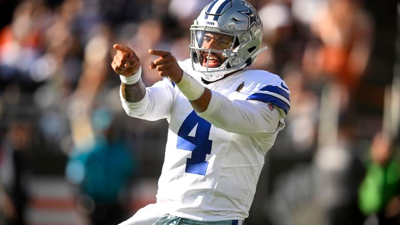 Dallas Cowboys quarterback Dak Prescott celebrates Ezekiel Elliott's touchdown run against the Cleveland Browns in the first half of an NFL football game in Cleveland, Sunday, Sept. 8, 2024. (AP Photo/David Richard)