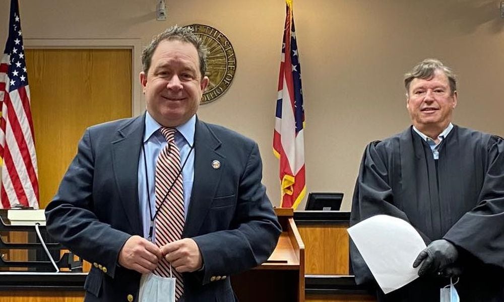 Montgomery County Clerk of Courts Mike Foley, left, and Montgomery County Municipal Court Judge James Piergies were indicted Wednesday, July 31, 2024, in a public corruption case. They are shown after Piergies swore in Foley in December 2020. CONTRIBUTED