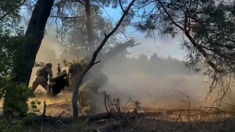 In this photo taken from video released by the Russian Defense Ministry on Friday, July 12, 2024, Russian soldiers fire from their howitzer from their position at Ukrainian troops at an undisclosed location in Ukraine. (Russian Defense Ministry Press Service via AP)