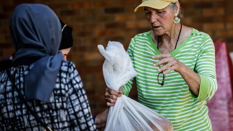 Community Gem Lucy Figner is a volunteer at Good Neighbor House food pantry on East First Street in Dayton. JIM NOELKER/STAFF