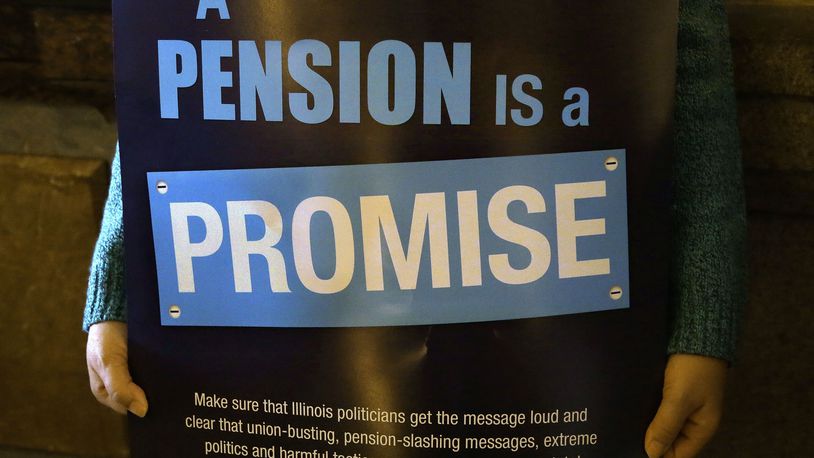 FILE - In this Jan. 3, 2013 photo, a "Pension Promise" sign is seen at the Illinois State Capitol in Springfield Ill., Jan. 3, 2013. Democrats are putting a spotlight on more than than 1 million union workers and retirees whose pensions are being saved under a law enacted in the summer of 2021. The Butch Lewis Act will ultimately stop cuts to the retirement benefits of 2 million workers and retirees across the country. The law was part of the American Rescue Plan passed by Congress along party lines to ultimately stall the insolvency of roughly 200 multi-employer pension plans for 30 years. (AP Photo/Seth Perlman, File)