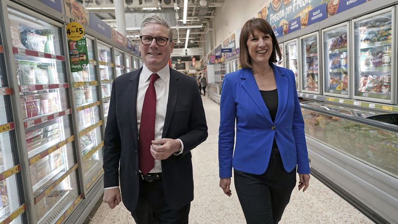Labour Party leader Keir Starmer, left, and shadow chancellor Rachel Reeves to a supermarket while on the general election campaign trail, in Wiltshire, England, Wednesday, June 19, 2024. (Stefan Rousseau/PA via AP)