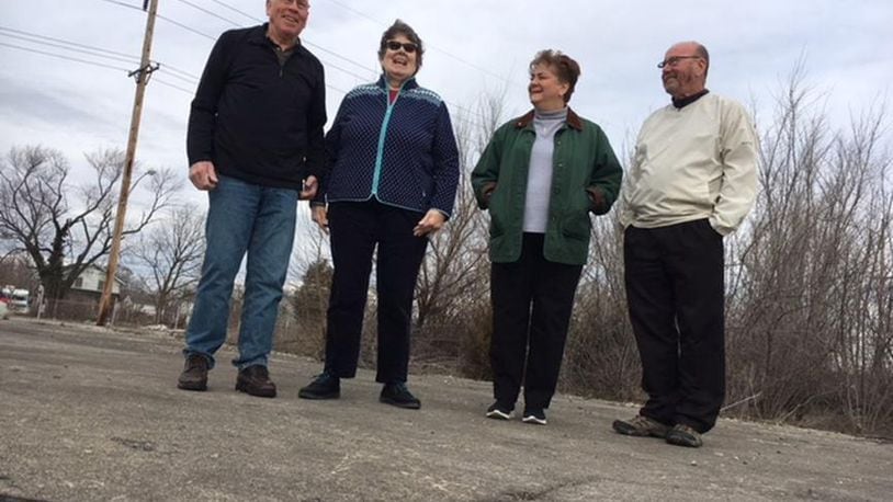 Dayton-area Delphi salaried retirees (from left), Tom Rose, Mary Miller, Marlane Bengry and Tom Green, standing on the foundation of the former Delphi Wisconsin Boulevard plant in Dayton. This photo was taken in March 2018. THOMAS GNAU/STAFF