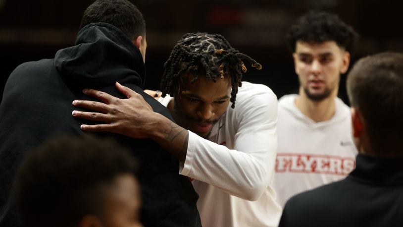 Dayton's DaRon Holmes II gets a hug from Obi Toppin before a game against Fordham on Tuesday, Jan. 10, 2023, at Rose Hill Gym in Bronx, N.Y. David Jablonski/Staff