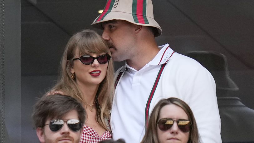 Taylor Swift, left, and Travis Kielce watch play between Jannik Sinner, of Italy, and Taylor Fritz, of the United States, during the men's singles final of the U.S. Open tennis championships, Sunday, Sept. 8, 2024, in New York. (AP Photo/Kirsty Wigglesworth)