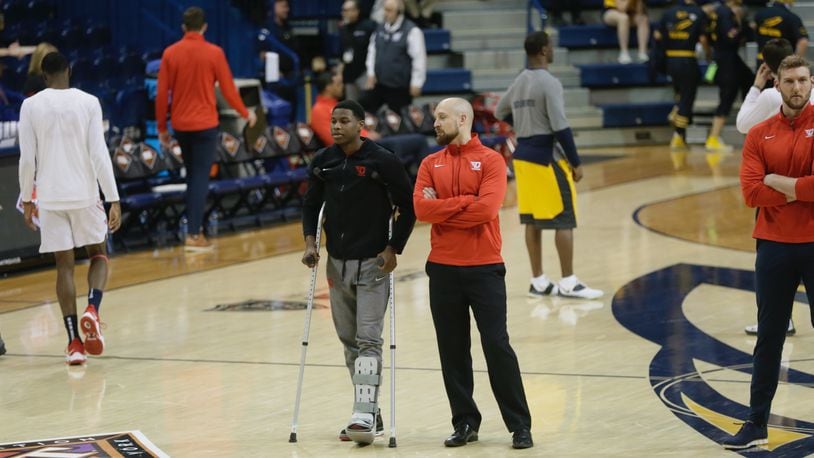 Malachi Smith stands next to strength coach Casey Cathrall as his teammates warm up for a game against Toledo in the first round of the NIT on Wednesday, March 16. 202, at Savage Arena in Toledo. David Jablonski/Staff