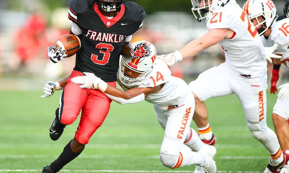 Franklin's Malachi Gipson (3) is tackled by Fenwick's Sean Heberling (14) during their season opener on Friday night at Franklin's Atrium Stadium. Kyle Hendrix/CONTRIBUTED