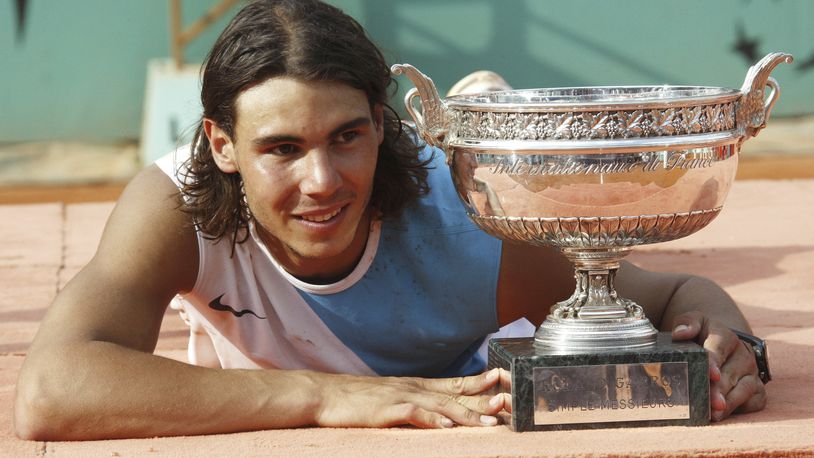 FILE - Spain's Rafael Nadal poses with the cup after defeating Switzerland's Roger Federer during the men's final match of the French Open tennis tournament at Roland Garros stadium in Paris, Sunday, June 10, 2007. Nadal won 6-3, 4-6, 6-3, 6-4. (AP Photo/Michel Spingler, File)