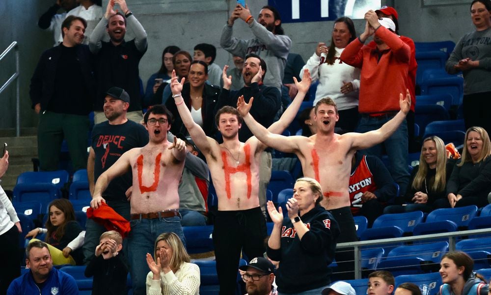 Friends of Dayton's Brady Uhl show off their painted chests during a game against Saint Louis on Tuesday, March 5, 2024, at Chaifetz Arena in St. Louis, Mo. David Jablonski/Staff