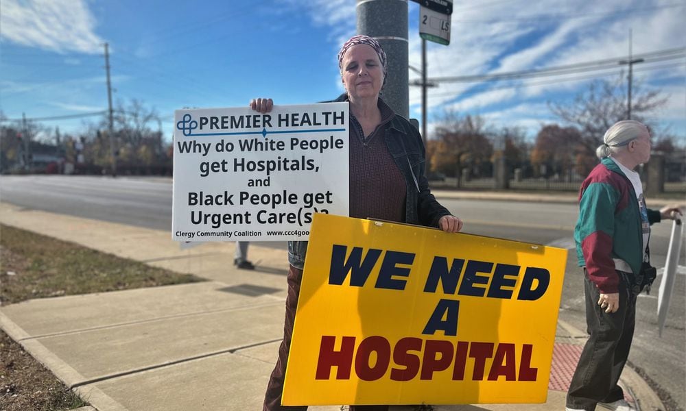 Nancy Kiehl, a member of the Clergy Coalition Community, protests outside of a ceremonial groundbreaking event on Friday, Oct. 28, 2022, for a new facility on the former Good Samaritan Hospital site. CORNELIUS FROLIK / STAFF