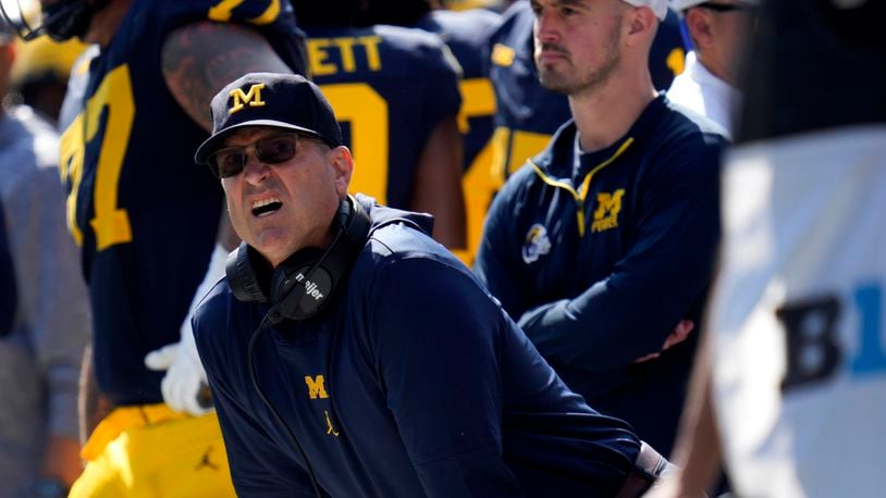 FILE - Michigan head coach Jim Harbaugh, front left, watches against Rutgers as analytics assistant Connor Stalions, right, looks on during an NCAA college football game in Ann Arbor, Mich., Sept. 23, 2023. (AP Photo/Paul Sancya, File)