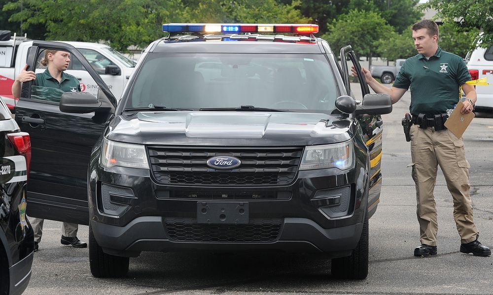 Reporter London Bishop and cadet Noah Thomas exit a cruiser during combined scenarios training at the Sinclair Police Academy. MARSHALL GORBY\STAFF