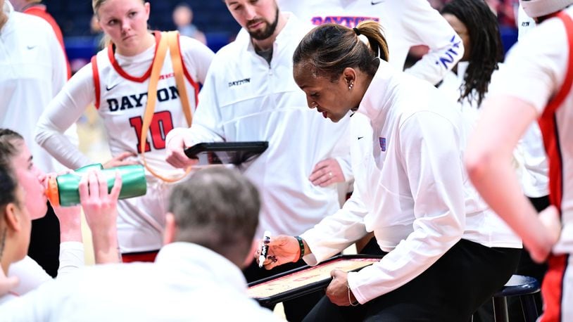 Dayton women's basketball coach Tamika Williams-Jeter draws up a play during a timeout in Saturday's game vs. Duquense at UD Arena. UD Athletics photo