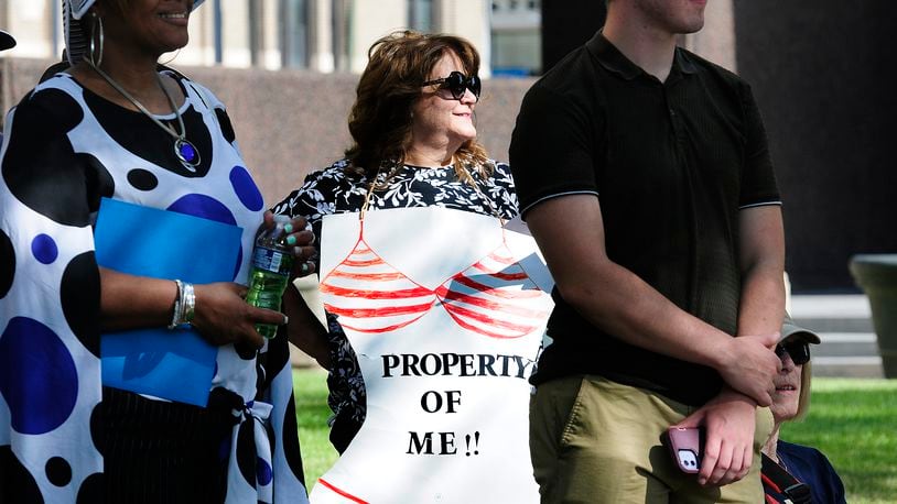 Ann Marie, proudly wears her 'Property of Me' sign Monday, June 24, 2024 at the Federal Building in Dayton while protesting anti-abortion efforts across the country and the Supreme Court's Dobbs decision two years ago. MARSHALL GORBY\STAFF