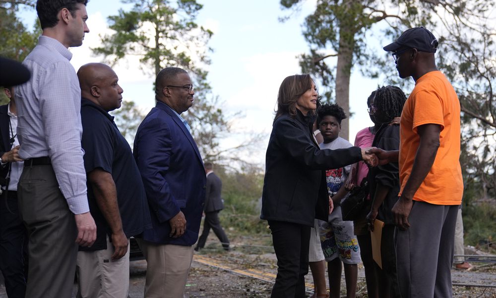 Democratic presidential nominee Vice President Kamala Harris greets people who were impacted by Hurricane Helene in Augusta, Ga., Wednesday, Oct. 2, 2024, as from left, Sen. Jon Ossoff, D-Ga., FEMA deputy direct Erik Hooks and Augusta Mayor Garnett Johnson watch. (AP Photo/Carolyn Kaster)