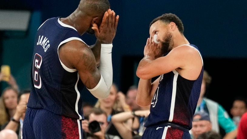 FILE - United States' Stephen Curry (4) and LeBron James (6) celebrate after beating France to win the gold medal during a men's gold medal basketball game at Bercy Arena at the 2024 Summer Olympics, Aug. 10, 2024, in Paris, France. (AP Photo/Mark J. Terrill, File)