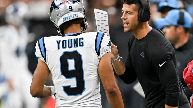 Carolina Panthers head coach Dave Canales right talks to quarterback Bryce Young (9) during the second half of an NFL football game against the New Orleans Saints, Sunday, Sept. 8, 2024, in New Orleans. (AP Photo/Matthew Hinton)