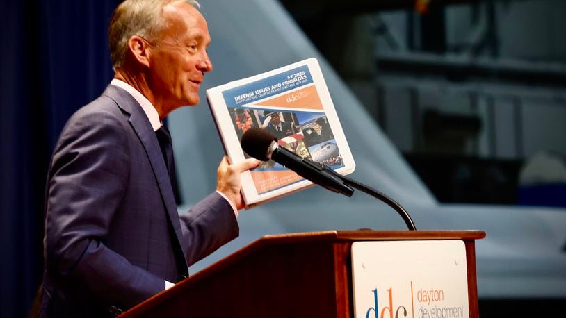 Jeff Hoagland, president and chief executive of the Dayton Development Coalition, holding a copy of the coalition's strategic plan. MARSHALL GORBY/STAFF