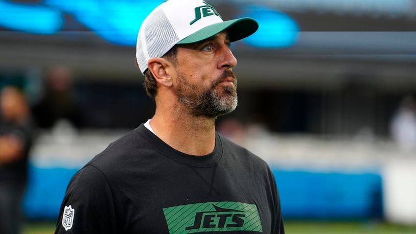 New York Jets quarterback Aaron Rodgers walks on the field before a preseason NFL football game against the Carolina Panthers, Saturday, Aug. 17, 2024, in Charlotte, N.C. (AP Photo/Jacob Kupferman)