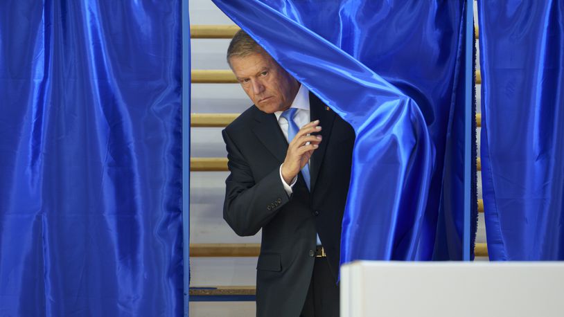 Romanian President klaus Iohannis exits a voting cabin during European and local elections in Bucharest, Romania, Sunday, June 9, 2024. Voters across the European Union are going to the polls on the final day of voting for the European parliamentary elections to choose their representatives for the next five-year term. (AP Photo/Andreea Alexandru)