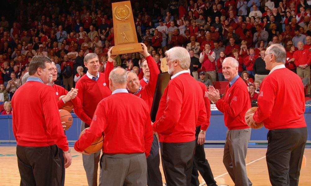 Bobby Joe Hooper, center, hoists the Dayton Flyers' 1967 NCAA runner-up trophy during a 40th reunion celebration at UD Arena in 2007. Photo by Timothy Boone