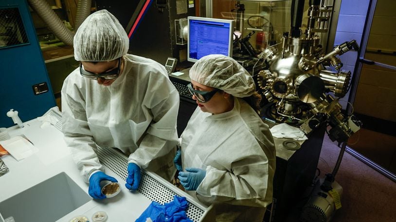 University of Dayton electrical engineering student Malia Hoffmire, left, and UD OASIS program participant Leah Dalton work in the Kettering Lab on the UD campus Monday April 22, 2024. The two women are making semiconductors. JIM NOELKER/STAFF