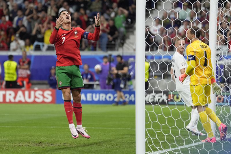Portugal's Cristiano Ronaldo reacts after missing a scoring chance during a round of sixteen match between Portugal and Slovenia at the Euro 2024 soccer tournament in Frankfurt, Germany, Monday, July 1, 2024. (AP Photo/Ariel Schalit)
