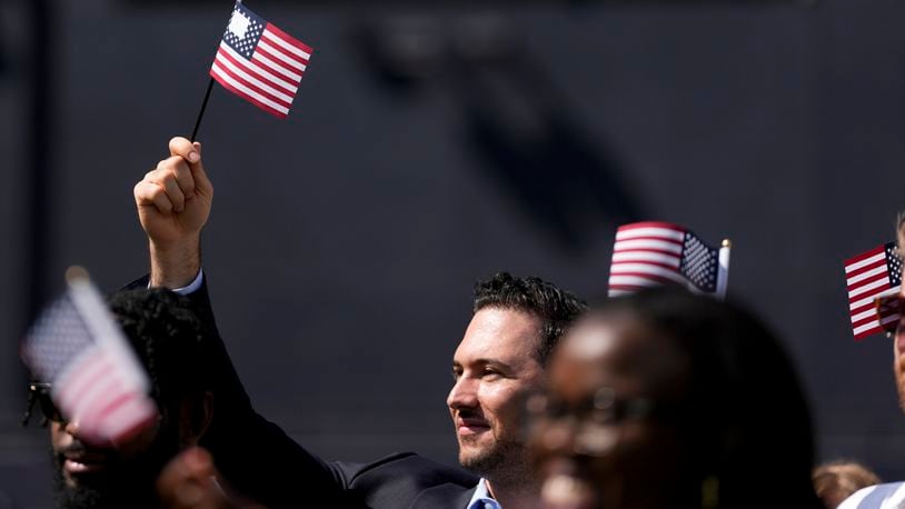 A man, part of a group of 50 new United States citizens from 25 different countries, takes part in a naturalization ceremony before the San Diego Padres host the Minnesota Twins in a baseball game at Petco Park, Wednesday, Aug. 21, 2024, in San Diego. (AP Photo/Gregory Bull)