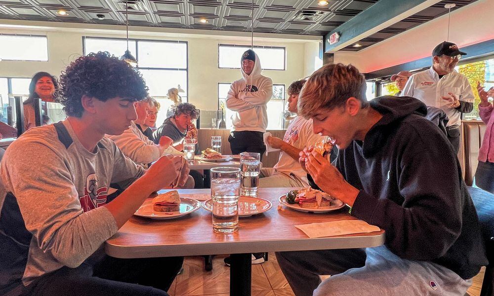 Student athletes from Centerville High School and The Miami Valley School battled head-to-head on Oct. 22 to see who could eat All The Best Delicatessen’s secret menu item, “The Stupid-Big Sandwich,” in the fastest time. CONTRIBUTED PHOTO